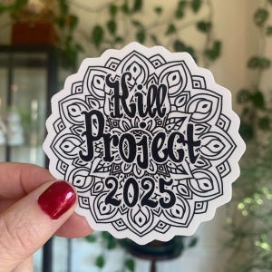 May include: Black and white sticker featuring a mandala design. The text "Kill Project 2025" is written in a stylised font.
