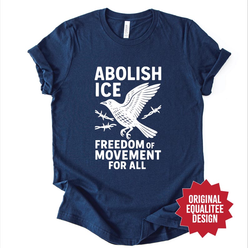 May include: Navy blue t-shirt with the words "ABOLISH ICE" above a white bird graphic with barbed wire and the text "FREEDOM OF MOVEMENT FOR ALL". The shirt also has a red star-shaped design that says "ORIGINAL EQUALITEE DESIGN".