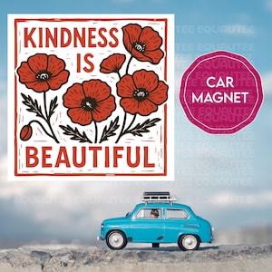 Op de afbeelding: Een vierkante afbeelding met de woorden "KINDNESS IS BEAUTIFUL" en rode klaprozen. Een magneet voor de auto met de tekst "CAR MAGNET" staat naast de afbeelding. Een kleine blauwe auto staat op de voorgrond.