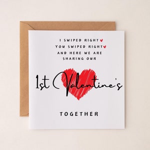 May include: A white card with a red heart and black text that reads "I swiped right, you swiped right, and here we are sharing our 1st Valentine's together."