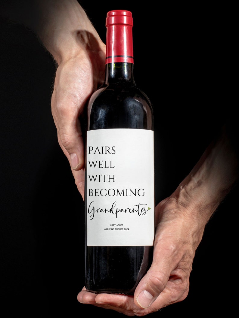 May include: A bottle of red wine with a white label that reads "Pairs well with becoming Grandparents" and "Baby Jones Arriving August 2024".