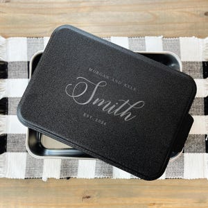 May include: Black metal baking pan with a lid. The lid has a personalized inscription that reads "Morgan and Kyle Smith Est 2024".