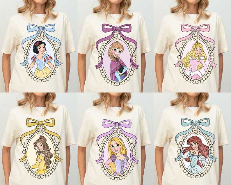 May include: Six cream-colored t-shirts with a different Disney princess in each. Each princess is in a pearl-like oval frame with a pink, purple, blue, or yellow bow at the top. The princesses are Snow White, Elsa, Aurora, Belle, Rapunzel, and Ariel.
