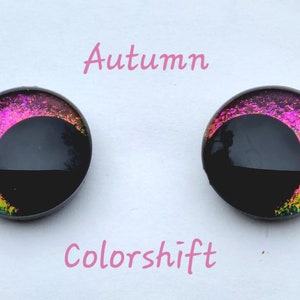May include: Pair of black and iridescent glass eyes with a pink and gold color shift. The eyes are labeled "Autumn Colorshift".