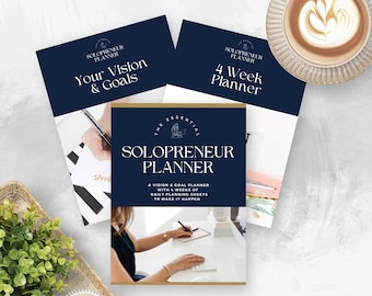 May include: A set of three blue and gold planners with the text "Solopreneur Planner" and "The Essential" on the front cover. The planners are titled "Your Vision & Goals", "4 Week Planner", and "Solopreneur Planner".