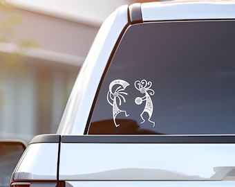 May include: White vinyl decal of two stylized figures dancing, with geometric patterns, on a silver car window.