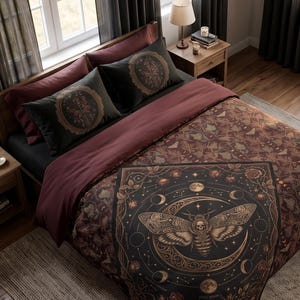 May include: A bedding set featuring a dark brown and black comforter with a large central graphic of a moth, a crescent moon, and celestial phases. The set includes two matching pillowcases with circular moth designs and a deep maroon bed sheet.