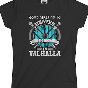 May include: Black t-shirt featuring a shield design with the text "Good Girls Go To Heaven, Bad Bitches Go To Valhalla." The design includes crossed swords and a blue and white shield. A round neck t-shirt.