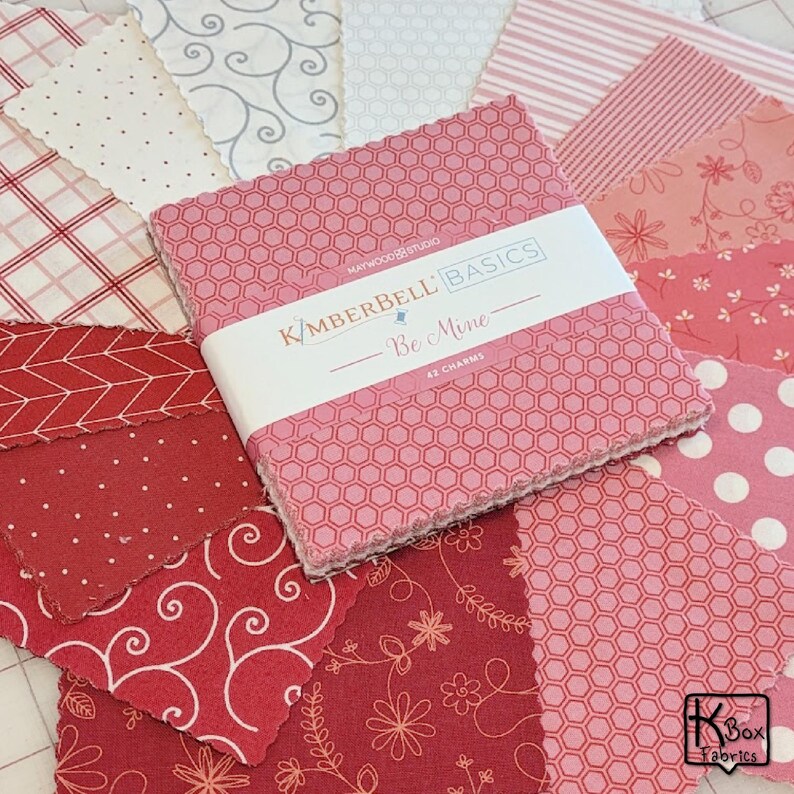 Precut bundle 5" charm pack fabric stacker includes 42 square 5" x 5" pieces. Kimberbell Basics The Be Mine line from Maywood Studio. Red, Pink and White quality quilting cotton fabric charm pack. Precut quilting cotton squares great blenders for quilting and embroidering. Great fabric bundle for quilters and crafters.