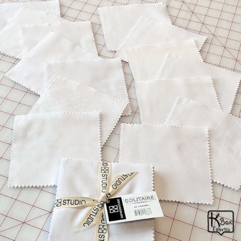 Precut bundle 5 inch charm pack fabric stacker includes 42 pieces. Cotton fabric charm pack from Maywood Studio. This cute white on white charm pack has hearts, stars, swirls, flowers and so much more. Great fabric bundle for quilters and crafters.