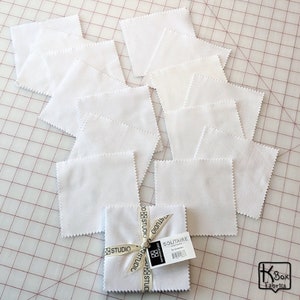 Precut bundle 5 inch charm pack fabric stacker includes 42 pieces. Cotton fabric charm pack from Maywood Studio. This cute white on white charm pack has hearts, stars, swirls, flowers and so much more. Great fabric bundle for quilters and crafters.