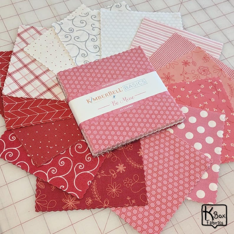 Precut bundle 5" charm pack fabric stacker includes 42 square 5" x 5" pieces. Kimberbell Basics The Be Mine line from Maywood Studio. Red, Pink and White quality quilting cotton fabric charm pack. Precut quilting cotton squares great blenders for quilting and embroidering. Great fabric bundle for quilters and crafters.