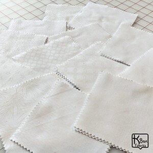 Precut bundle 5 inch charm pack fabric stacker includes 42 pieces. Cotton fabric charm pack from Maywood Studio. This cute white on white charm pack has hearts, stars, swirls, flowers and so much more. Great fabric bundle for quilters and crafters.