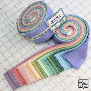 May include: Two rolls of fabric strips in a rainbow of colors, with a label that reads "Shadow Play". The strips are 2.5 inches wide and are arranged in a spiral. The fabric is a soft, textured material.