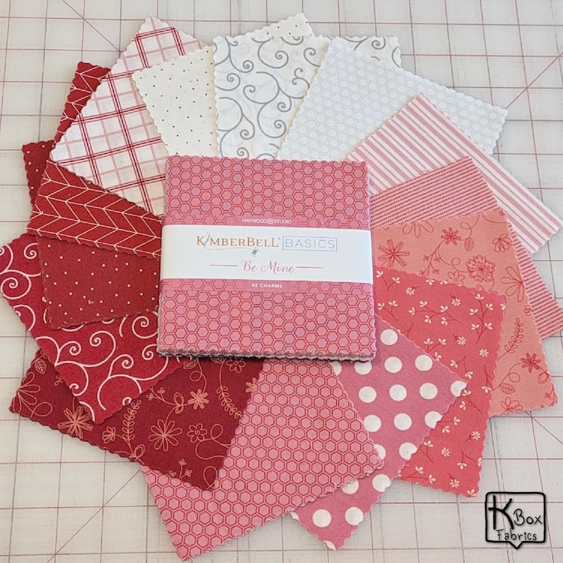 Precut bundle 5" charm pack fabric stacker includes 42 square 5" x 5" pieces. Kimberbell Basics The Be Mine line from Maywood Studio. Red, Pink and White quality quilting cotton fabric charm pack. Precut quilting cotton squares great blenders for quilting and embroidering. Great fabric bundle for quilters and crafters.