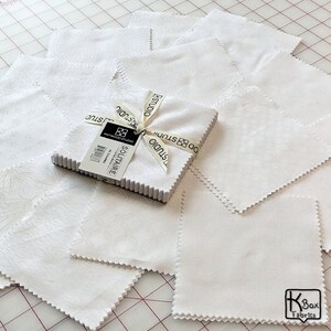 Precut bundle 5 inch charm pack fabric stacker includes 42 pieces. Cotton fabric charm pack from Maywood Studio. This cute white on white charm pack has hearts, stars, swirls, flowers and so much more. Great fabric bundle for quilters and crafters.