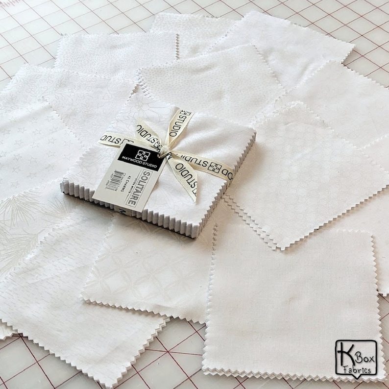 Precut bundle 5 inch charm pack fabric stacker includes 42 pieces. Cotton fabric charm pack from Maywood Studio. This cute white on white charm pack has hearts, stars, swirls, flowers and so much more. Great fabric bundle for quilters and crafters.