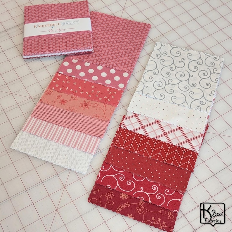 Precut bundle 5" charm pack fabric stacker includes 42 square 5" x 5" pieces. Kimberbell Basics The Be Mine line from Maywood Studio. Red, Pink and White quality quilting cotton fabric charm pack. Precut quilting cotton squares great blenders for quilting and embroidering. Great fabric bundle for quilters and crafters.
