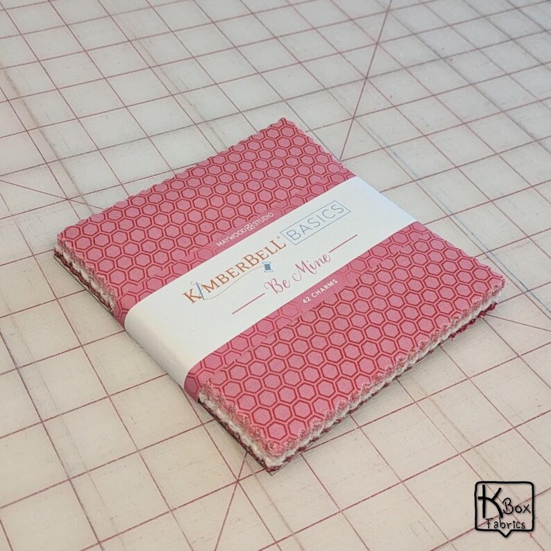 Precut bundle 5" charm pack fabric stacker includes 42 square 5" x 5" pieces. Kimberbell Basics The Be Mine line from Maywood Studio. Red, Pink and White quality quilting cotton fabric charm pack. Precut quilting cotton squares great blenders for quilting and embroidering. Great fabric bundle for quilters and crafters.