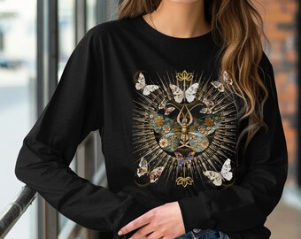 May include: Black long-sleeve shirt with a gold and floral butterfly design. The butterfly is surrounded by a golden halo with rays of light.