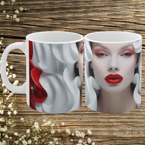 May include: White ceramic mug with a red and white abstract design on one side and a woman's face with red lipstick on the other side.