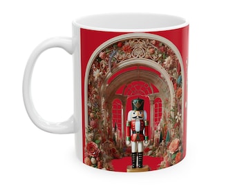 May include: White ceramic mug with a red background featuring a Nutcracker doll standing in a floral archway. The archway is decorated with gold and white details and has a red background.