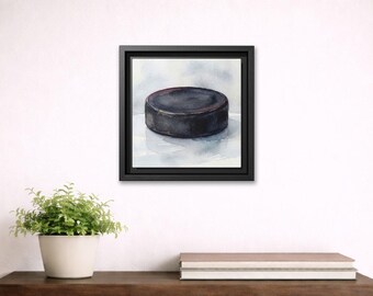 Quadro su tela incorniciato raffigurante un disco da hockey ad acquerello.