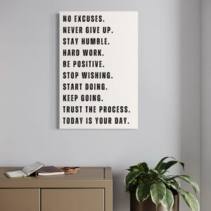 Minimalist white motivational wall art print with the phrases No Excuses, Never Give Up, Stay Humble, Trust the Process – Inspirational decor for home office, gym, or study space.