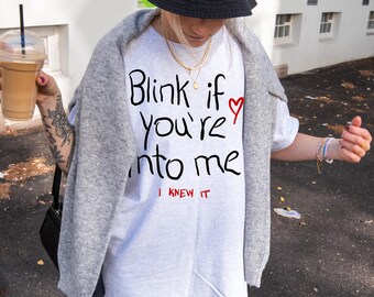 Unisex cotton T-shirt with funny front print &quot;Blink if you&#39;re into me&quot; in modern streetwear style