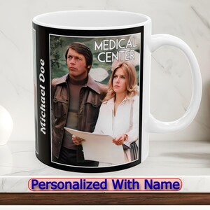 May include: White ceramic mug with a black and white image of two people and the text "MEDICAL CENTER". The mug is personalized with the name "Michael Doe".