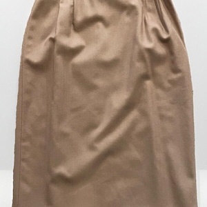 May include: A brown knee-length skirt with a straight silhouette and a simple design.