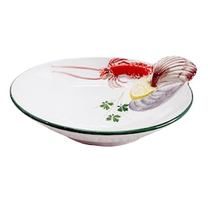 May include: A white ceramic bowl featuring a three-dimensional red lobster, a seashell, a slice of yellow lemon, and a painted green parsley sprig. The bowl has a dark green rim and a smooth, glossy finish, showcasing a nautical theme.