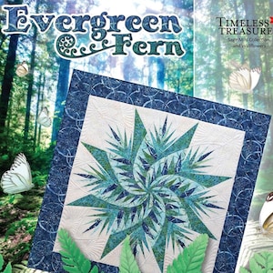 May include: A quilt pattern called "Evergreen Fern" from the Timeless Treasures Sage Mini Collection and Wallflowers. The quilt features a blue and green starburst design against a white background. The pattern is surrounded by a blue border with a fern design. The quilt is displayed in front of a green forest background.