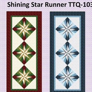 May include: A quilting pattern for a table runner called "Shining Star Runner TTQ-103" designed by Laureen Smith. The pattern features two color variations, one with green and red accents and the other with blue accents. The runner measures 25 inches by 59 inches.