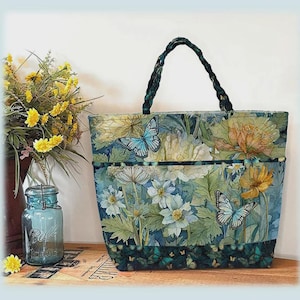 May include: A floral market tote bag with a braided handle. The bag features a botanical print with butterflies and flowers in shades of blue, green, and yellow. The tote is 14 inches high, 20.5 inches wide, and 6 inches deep.