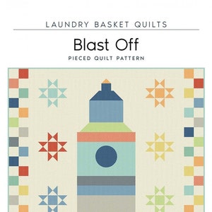 May include: A colourful quilt pattern titled "Blast Off" featuring a rocket ship design. The quilt measures 102.9 cm x 128.3 cm and includes star and square block accents. The rocket is blue, orange, and grey. The text "LAUNDRY BASKET QUILTS" is at the top.