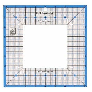 May include: A blue and white quilting ruler with a grid pattern. It has a 4 1/2 inch inner square and an 8 1/2 inch outer square. The ruler is labeled "Get Squared" and has the number "7-743" printed on it.