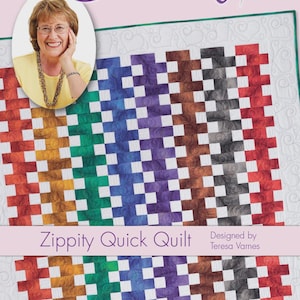 May include: A colourful quilt with a woven pattern in shades of red, orange, yellow, green, blue, purple, and grey. The quilt is titled "Zippity Quick Quilt" and designed by Teresa Varness. The image also features a woman with glasses.