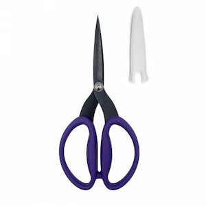 May include: A pair of scissors with a black blade and handle, and purple finger holes. A white protective cover is next to the scissors. The scissors are designed for cutting and trimming.