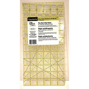 May include: A clear, non-slip quilting ruler with yellow grid lines and measurements in centimetres. The ruler is 15.24 cm x 30.48 cm and features the text "The Non-Slip Ruler for Quilting, Sewing & Crafts".