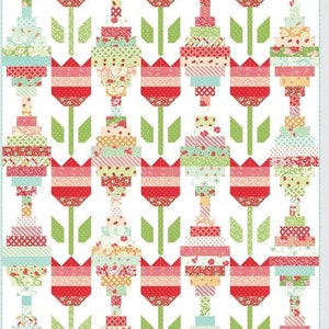 May include: A quilt pattern featuring a design of vintage tulips with a red, pink, green, and blue color scheme. The pattern is titled "Vintage Tulips" and numbered #187.