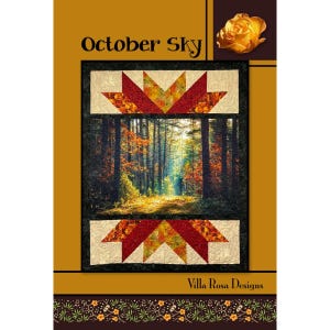 May include: A quilt pattern cover titled October Sky by Villa Rosa Designs. The design features a central photographic forest scene with autumn foliage, framed by geometric star-shaped borders in red, orange, and cream, with a yellow rose.