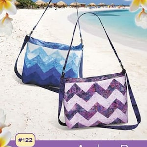 May include: A sewing pattern for a purple and white chevron Aruba bag. The pattern uses 2 1/2 inch strips and is fat quarter friendly. The pattern includes instructions for making the bag and optional purse hardware.