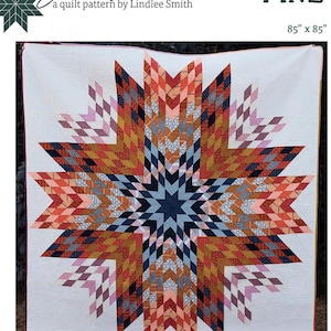 May include: A quilt pattern called "Big Sky Star" by Lindlee Smith. The quilt is made in a starburst pattern with a variety of colors, including red, orange, yellow, blue, and pink. The quilt is 85 inches by 85 inches.