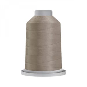 May include: A spool of beige thread for sewing or embroidery.