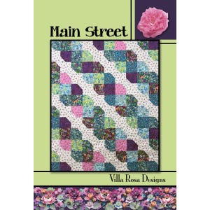 May include: A quilt pattern cover titled Main Street by Villa Rosa Designs. The quilt features a diagonal, interlocking block design in shades of purple, teal, pink, and green, set against a white background with small animal motifs.
