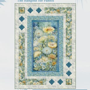 May include: A floral quilt panel featuring a central image of yellow and white flowers with butterflies, framed by blue and cream borders. The quilt measures 50" x 70" and is labeled "The Hangout for Panels" by Diamond-Square.