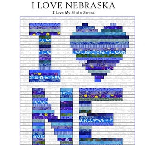 May include: A quilting pattern for a "I Love Nebraska" quilt. The pattern features the letters "I LOVE" in a heart shape, with each letter made up of different blue and purple fabric strips. The pattern includes instructions for a 37" x 45" and a 74" x 90" quilt.