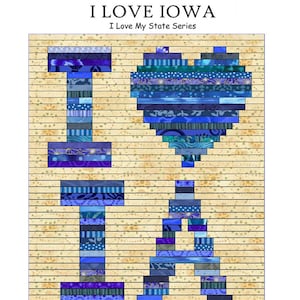 May include: A quilt pattern for a pieced quilt featuring the letters "I LOVE IOWA" in blue and purple fabrics on a yellow background. Instructions are included for a 37" x 45" and a 74" x 90" quilt.