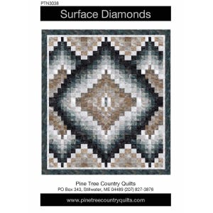 May include: A quilt pattern titled Surface Diamonds PTN3038 by Pine Tree Country Quilts. The design features a large central diamond motif composed of small square blocks in shades of charcoal, slate gray, beige, and white, framed by a dark border.